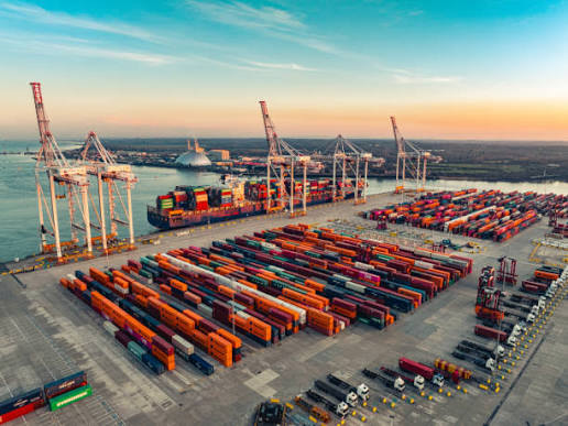Cargo containers, ships and trucks representing GCFF's land, sea and air logistics operations